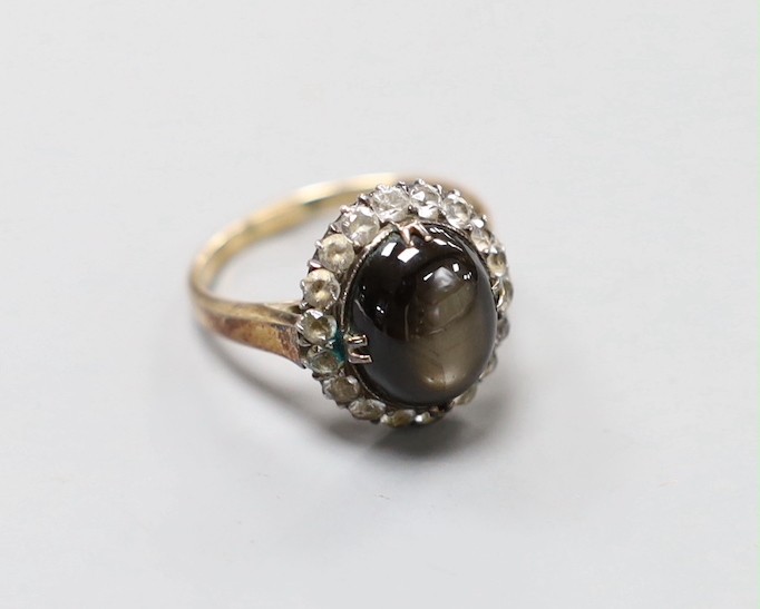 A 14k yellow metal, star sapphire and white sapphire? set oval cluster ring, size N, gross weight 4.5 grams.